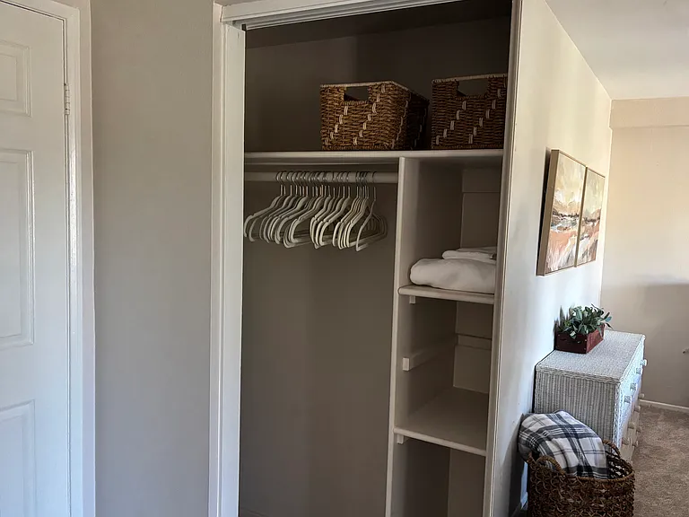 Large closet with hangers and baskets
