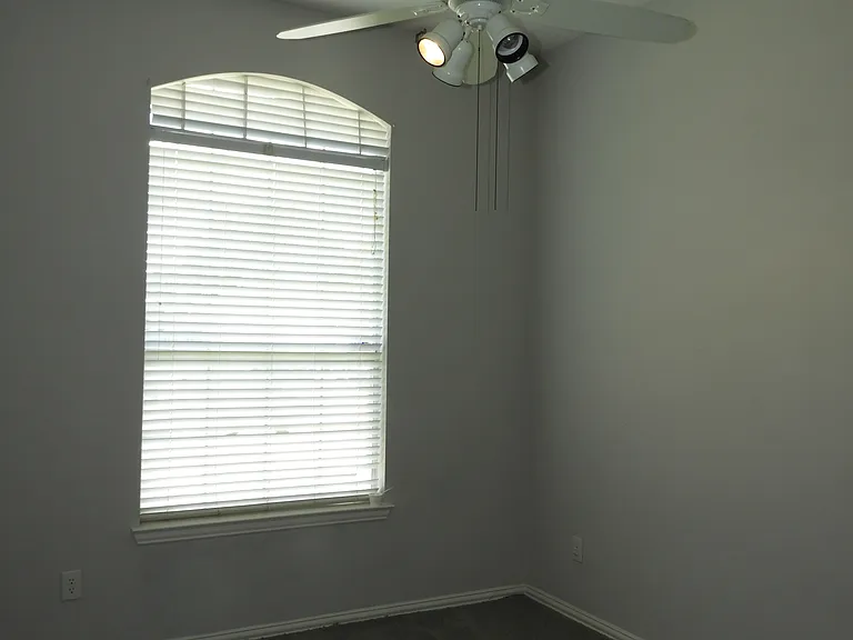 Bedroom 3 with ceiling fan and walk-in closet.