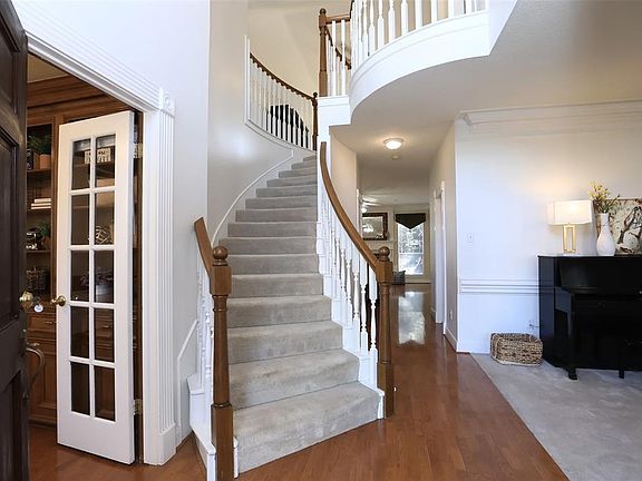 Two story entry with spiral stairs welcomes you.