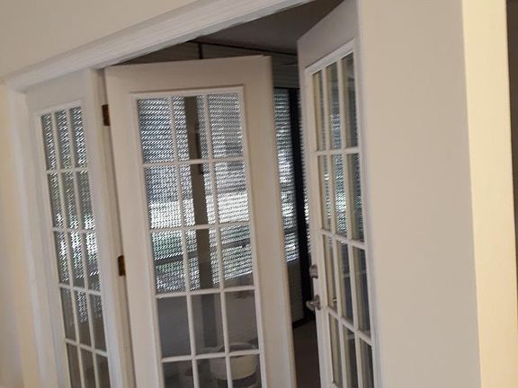 Frenchdoor access to balcony with hurricane shutters rolling