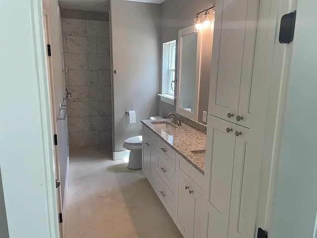 Primary bath with double sink, walk in shower and plenty of storage.