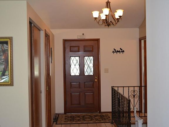 Front entry into the spacious foyer with newer chandelier.