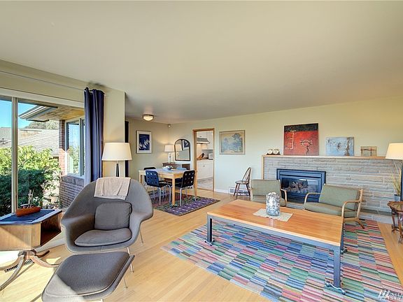 This great room encompasses a spacious dining area off the kitchen and a gas fireplace