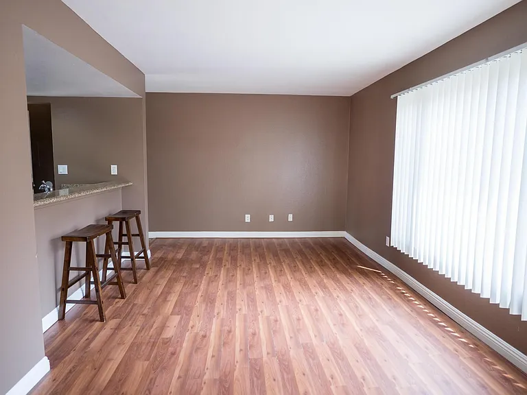 large open concept space for a dinner table, sofa/tv, with a large window that allows light in during the day, and can be closed with the shades drawn.