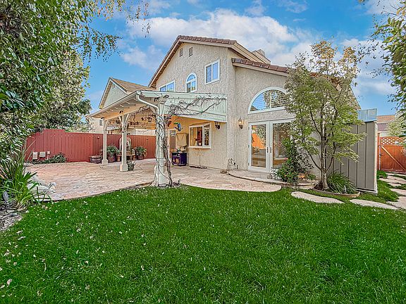 quiet and private back yard with a fountain and covered patio