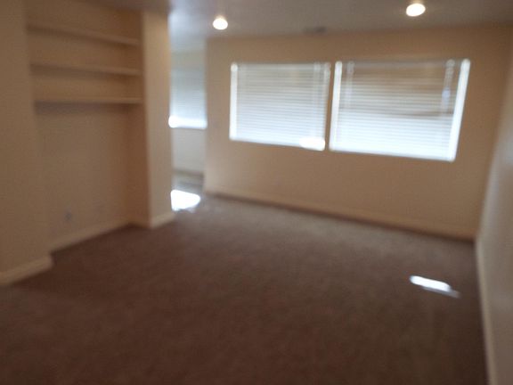 Large Living Room with built in TV area with free internet cable TV, and bookshelves; looking into Dining Room, top left