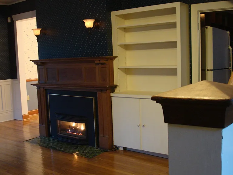 Fireplace with Vintage Lamps
Bookcase and Storage Cabinet
Dining Entry to Left, Kitchen Right
Stairway to Second Floor bottom Right