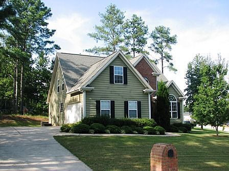 Two story home with master on main in golf course community. It sits on a double lot.
