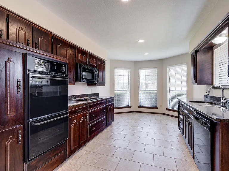 Built in microwave, cooktop and double ovens.