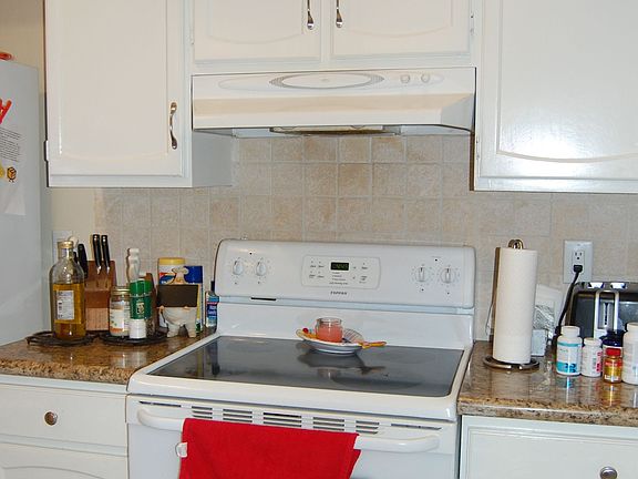 The kitchen has recent appliances, granite countertops, and a tile backsplash.