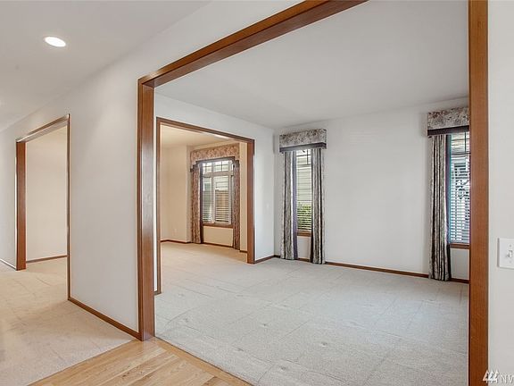 The entry has hardwood flooring and open sight lines to the spacious formal living and dining rooms. You'll find high ceilings and wood-wrapped archways in these lovely spaces.