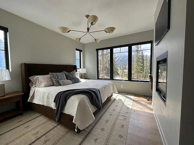 Primary bedroom with gas fireplace and views of Quandry.