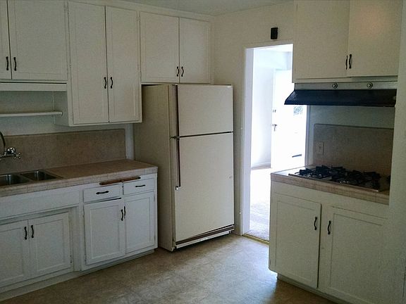 New kitchen sink, stove top, counters, and vinyl floors