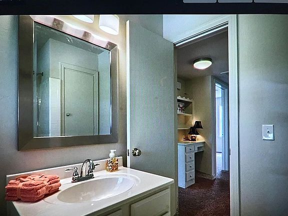 Full Bath View into Hallway with Built-In Desk