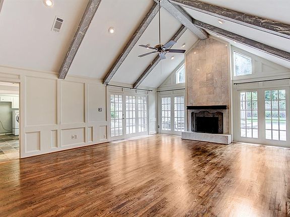WOW! Just look at this family room with it's Catherdal ceiling and wall of windows that face the pool! The cozy gas fireplace is a delightful accent point and the natural color scheme provides a grand space for gatherings.