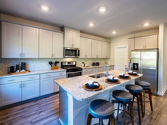 Prep dinner in the kitchen while entertaining in the great room. Photography from Holland Park.