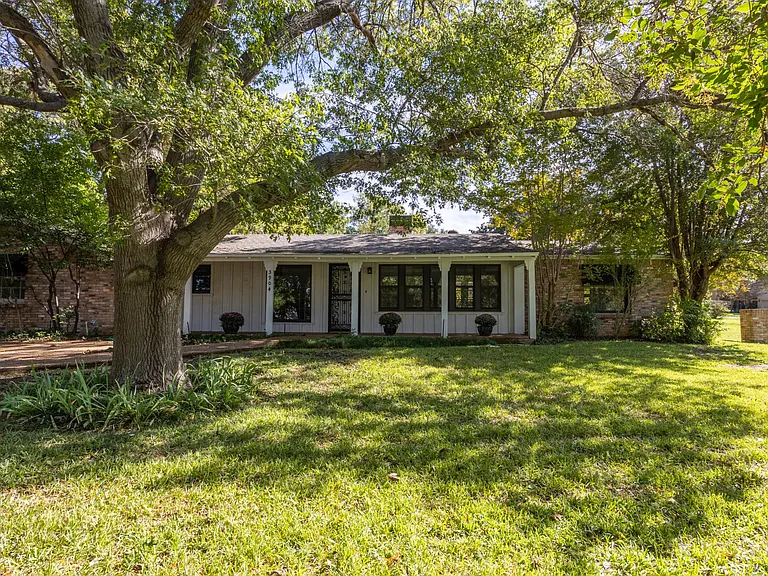 Front of the house. Drive and carport on the left