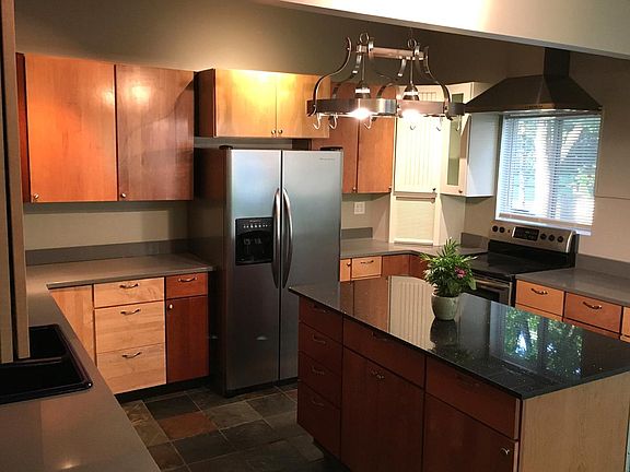 A chef's kitchen with granite island