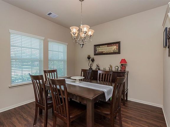 Formal dining with recently updated laminate wood floor.