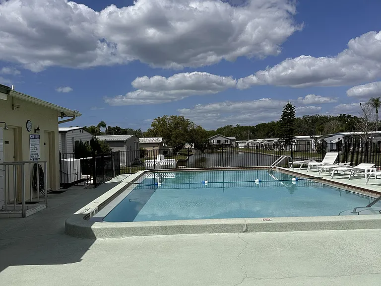 Community pool and Club House. Pond in the background