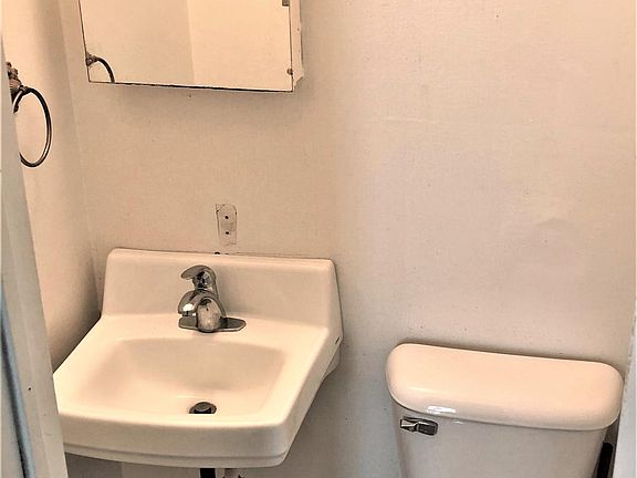 Half bath is downstairs. Full bathroom is located upstairs, with bedrooms.