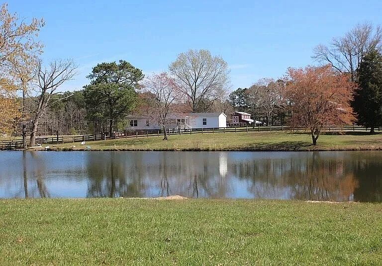 The large fully stocked fish pond in front of the home.