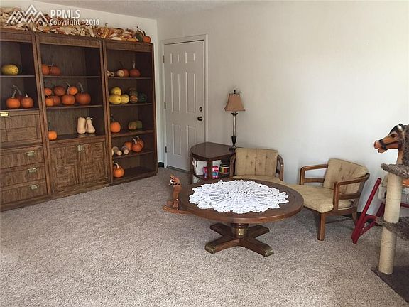 Living room view with access to attached garage.