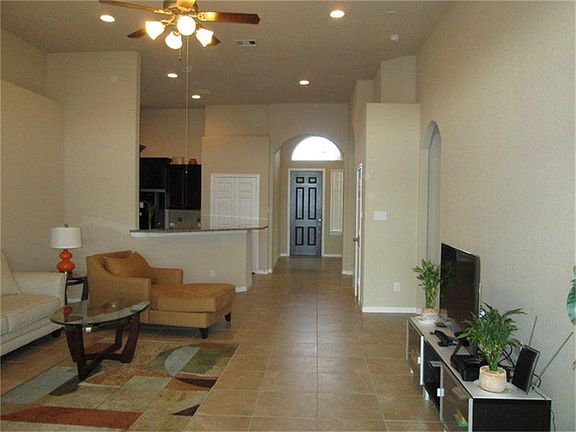 High ceiling entry and living area, front door with arch win
