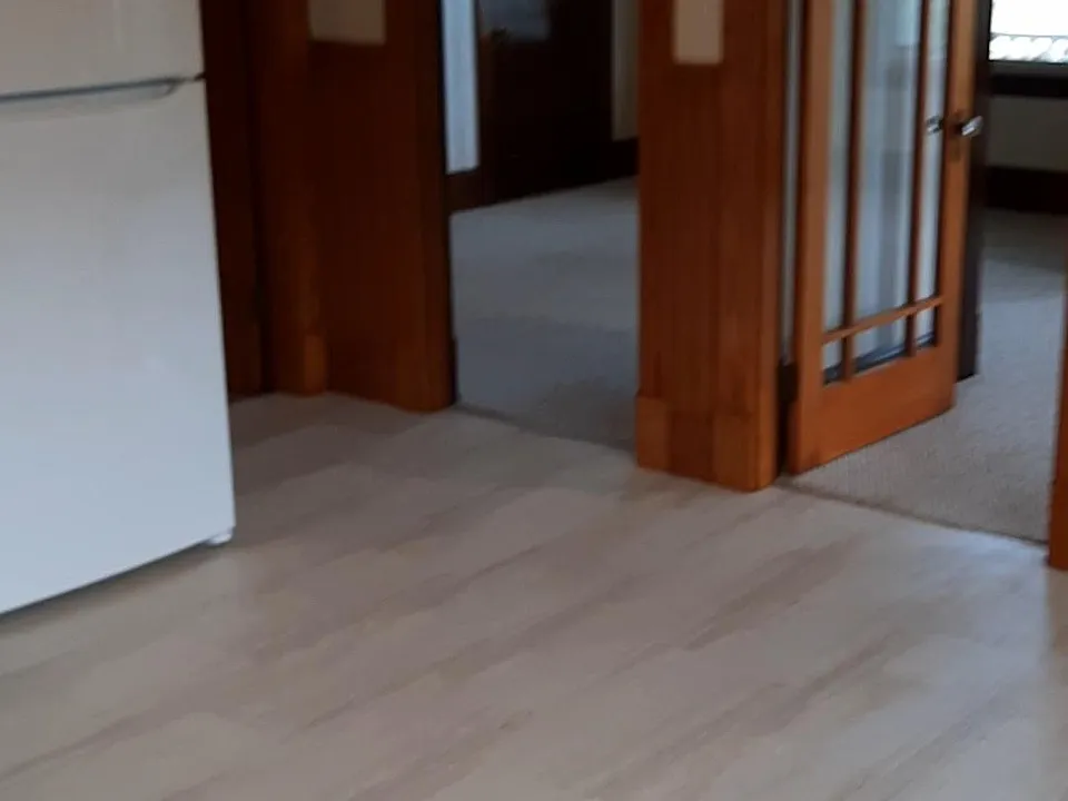Kitchen looking into living rooms with French doors.