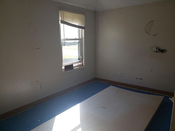 second bedroom with drywall on floor.