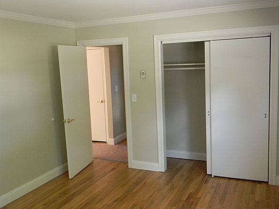 Bedroom w/ crown molding and large closet