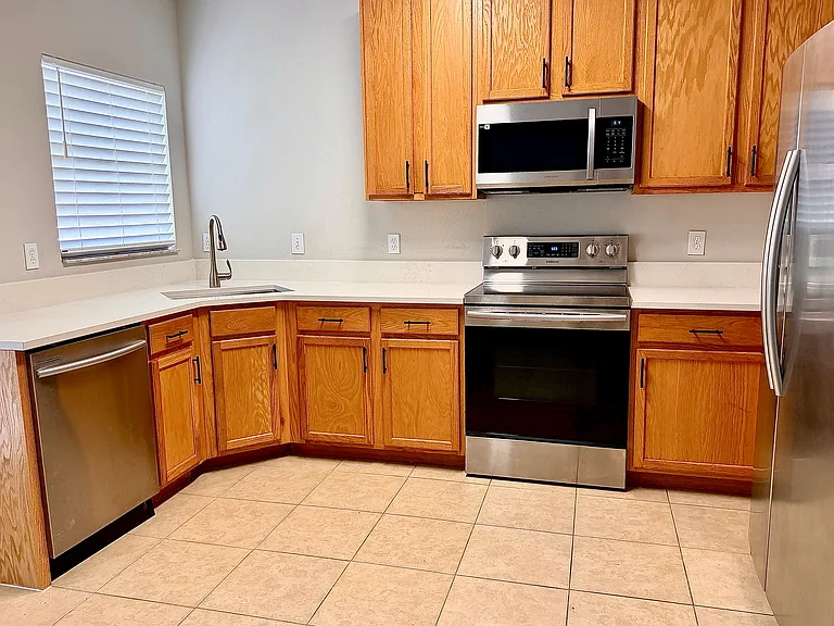 Kitchen with a brand new countertop and appliances that are a year old.