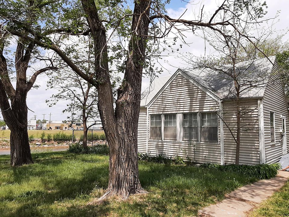Front of home, with river on west, with partial view of outside fenced backyard