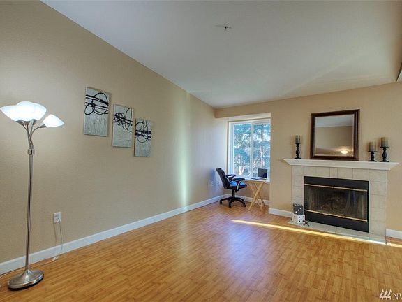 Living room with wood burning fireplace. 