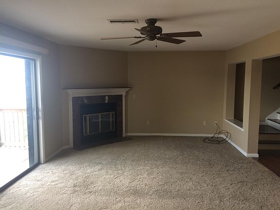 Fireplace in the living room. Sliding glass door opens to the balcony.