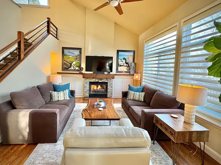 Open family room with huge windows, fireplace and vaulted ceilings