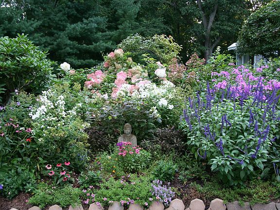 Buddha Garden in front of the waterfall garden that frames the free standing rental home.