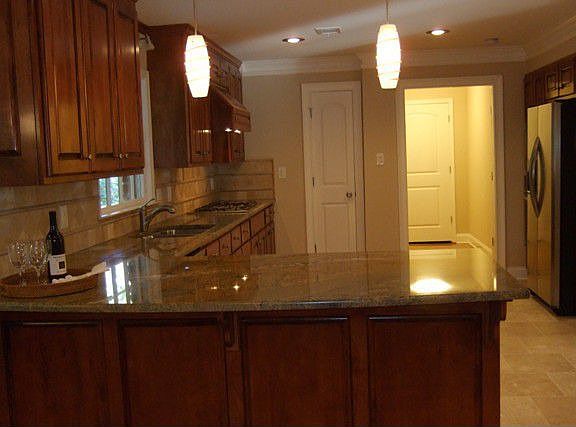 Huge Open Kitchen with custom maple cabinetry, Highest grade granite counters, decorator lighting th