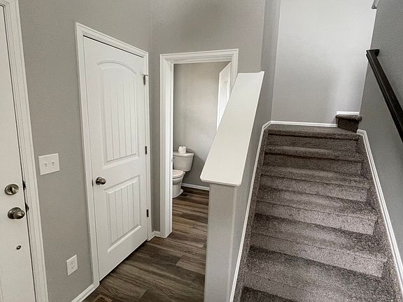 Half-bath and stairs in entry way