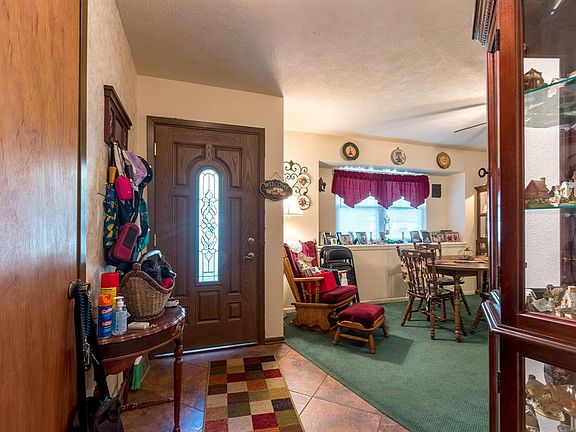 The attractive front door opens to the tile foyer and the dining room.