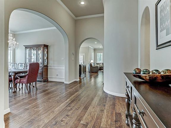 Open concept living with curved arches throughout along with beautiful wood floors.