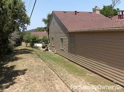 Side view
						:
						House sits atop beautiful cliff next to wooded walking trail.