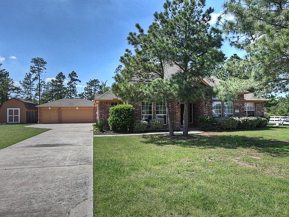 Home offers 3-car garage and storage shed w/electricity