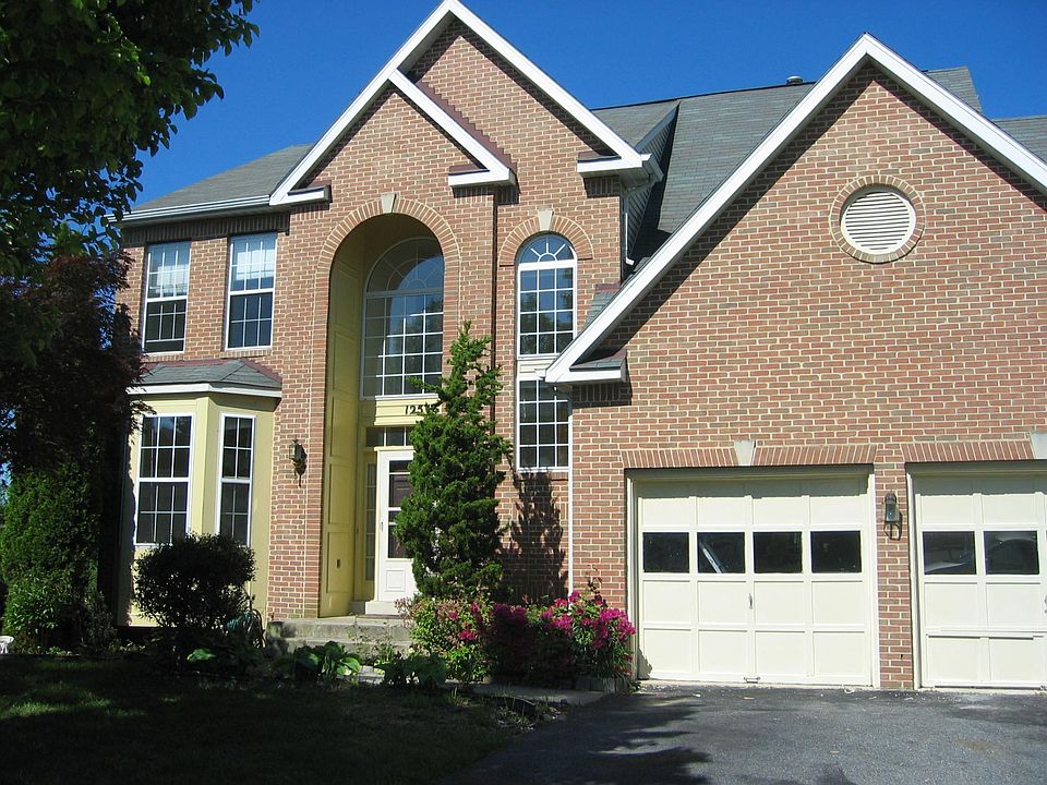Brickfront w/bay window and 2 car garage.