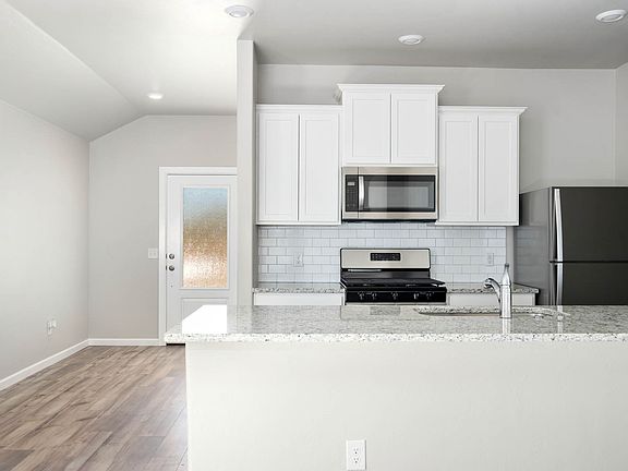 The kitchen of the Klein has beautiful white wood cabinets.