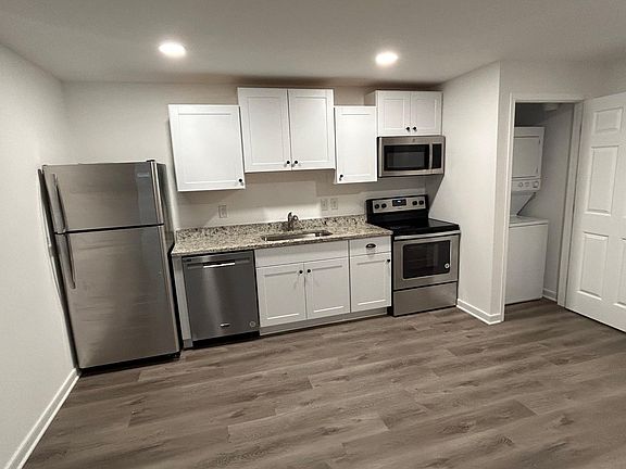 Kitchen with Dishwasher, Electric Stove Microwave, Disposal, Laundry right beside.