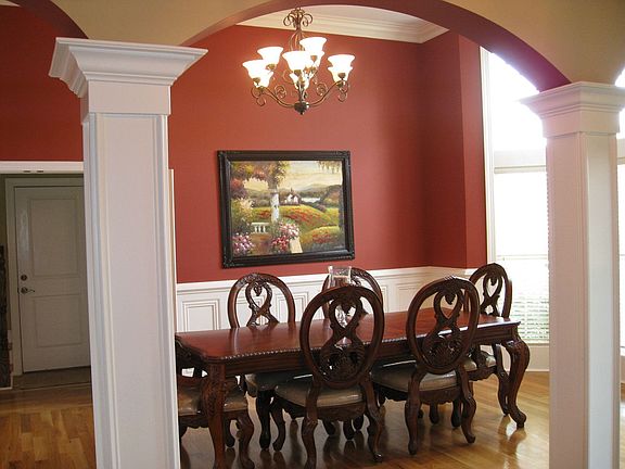 Grand arches lead into the formal dining room.