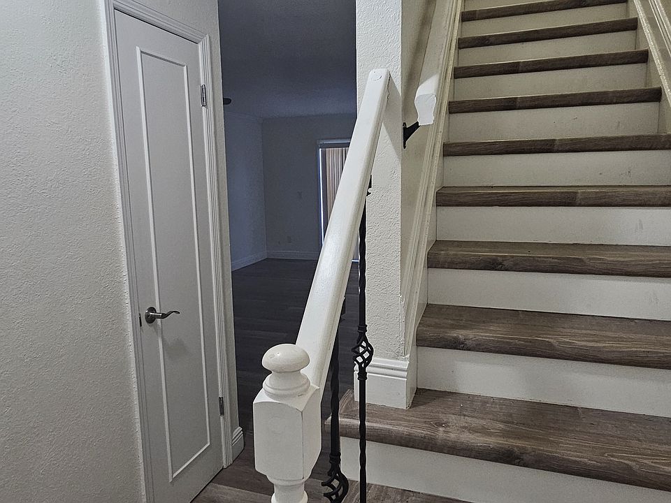 Photo from entrance to show the stairs to the top floor and to the living space and patio