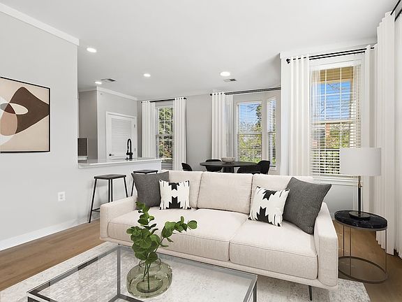 Renovated Package II dining and living room with hard surface flooring
