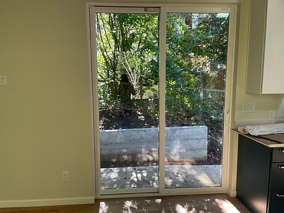 Sliding glass door to small patio and outdoor area.